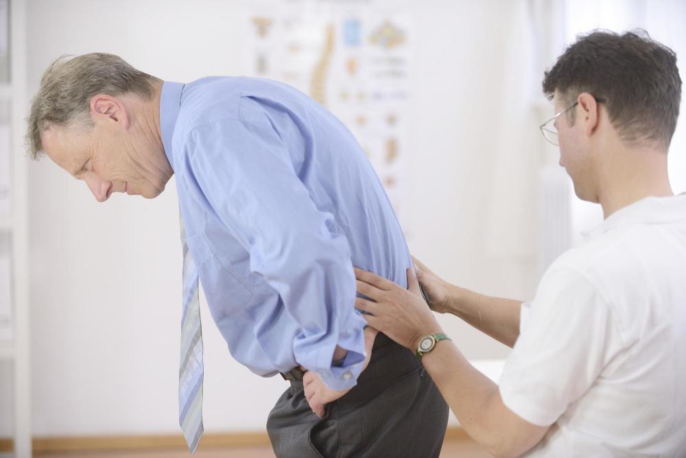 vancouver chiropractor examining patient with low back pain